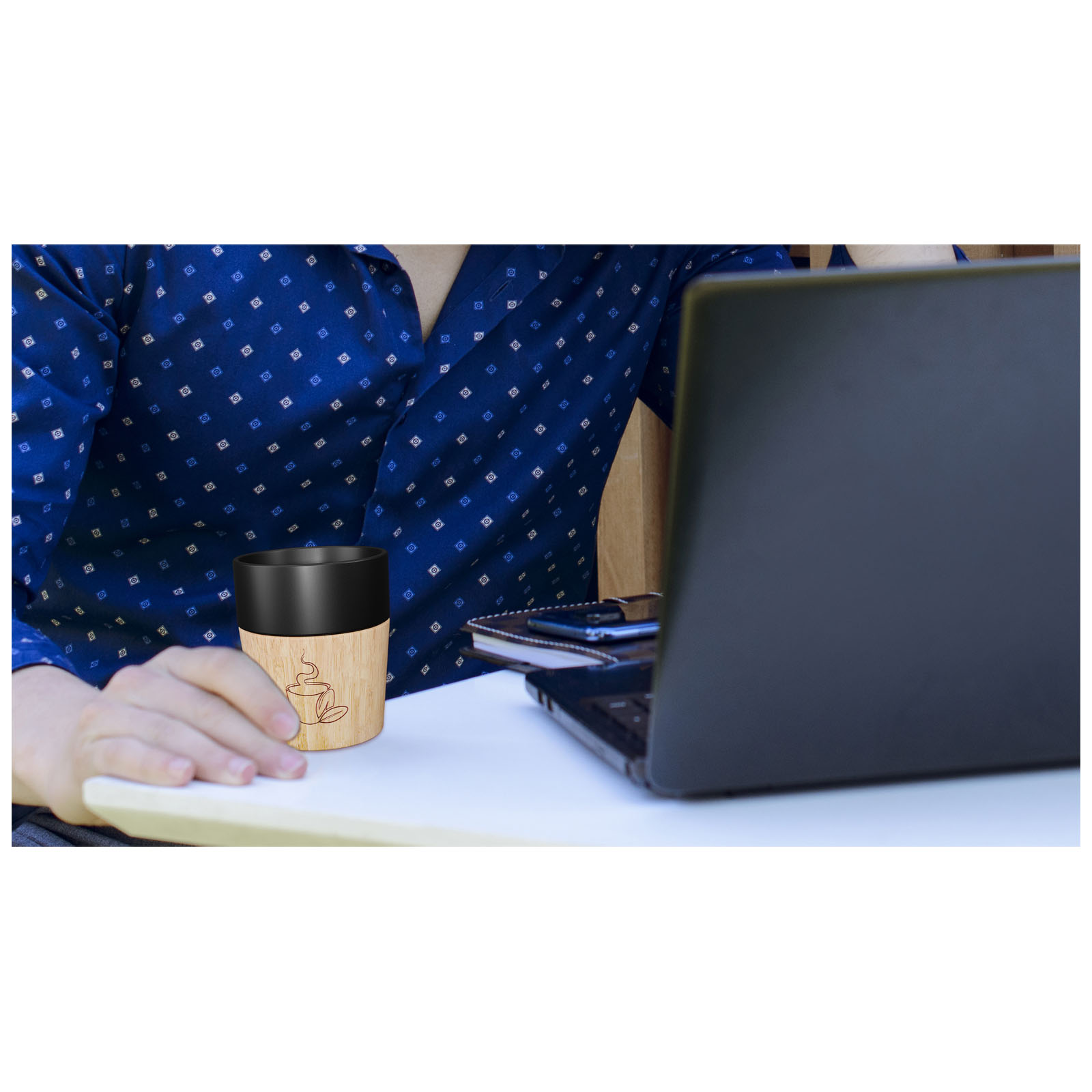 Serious businessman in speckled shirt, working with laptop remotely.